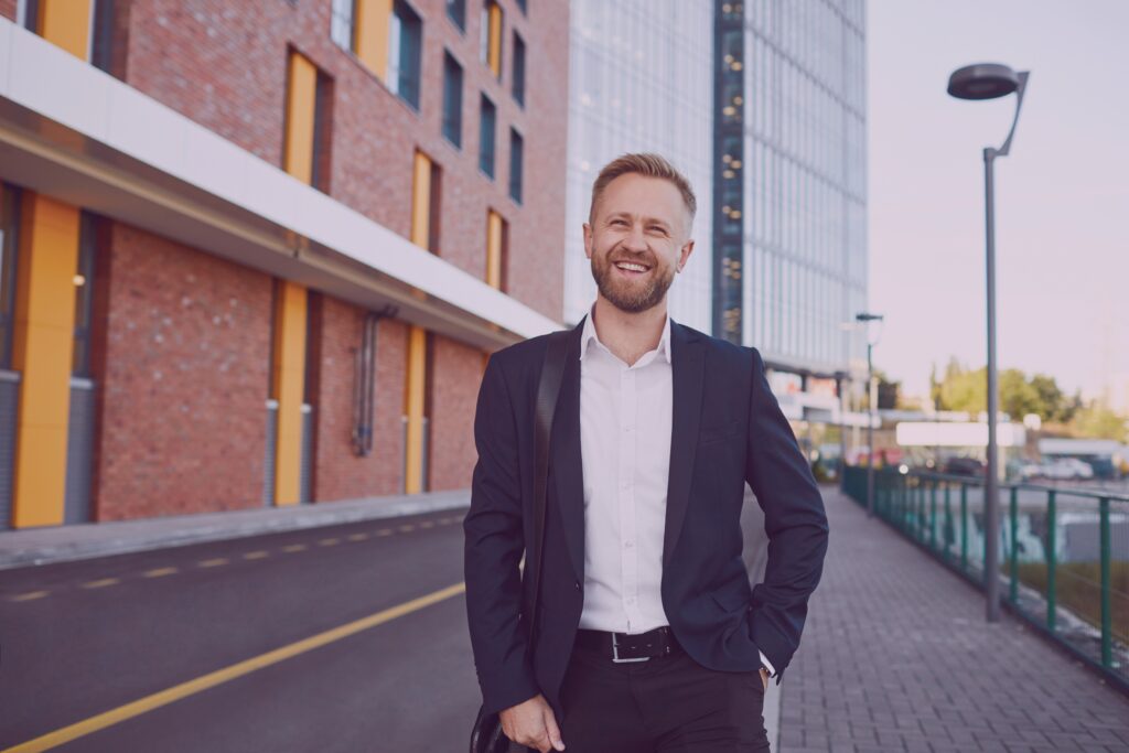 Smiling Businessman Standing on the street