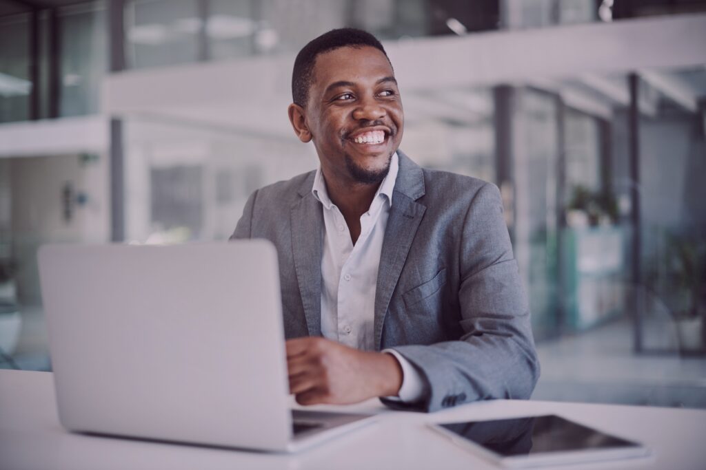 A worker smiling from his laptop