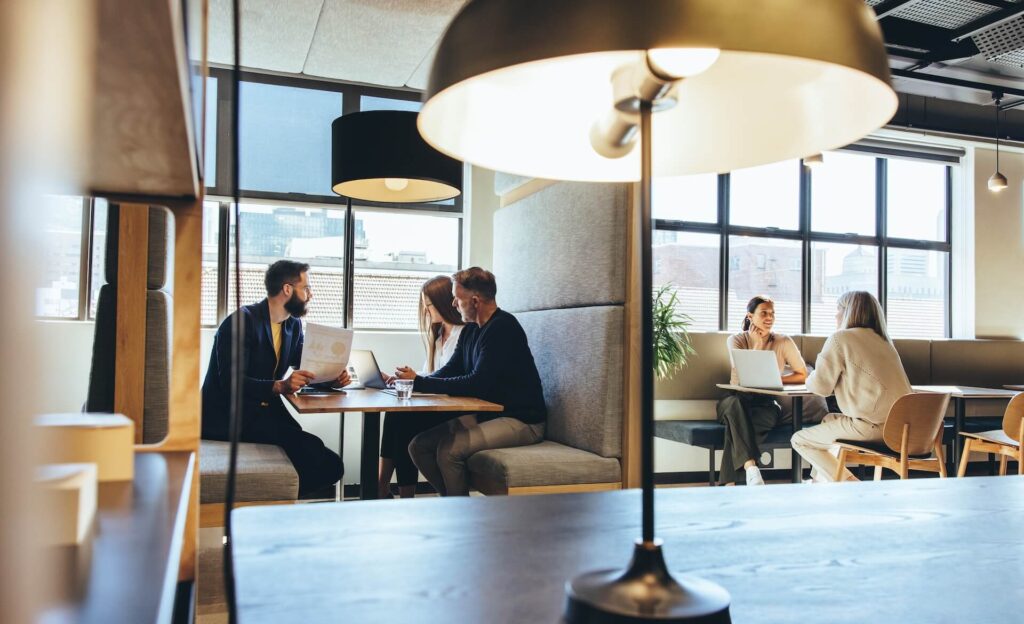 Three people sitting down to have a business meeting